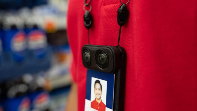 A store employee wearing the Augmodo Smartbadge